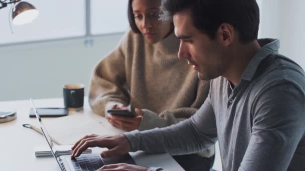 Businessman Working Laptop Desk Collaborating Female Colleague Using Mobile Phone — Stock Video