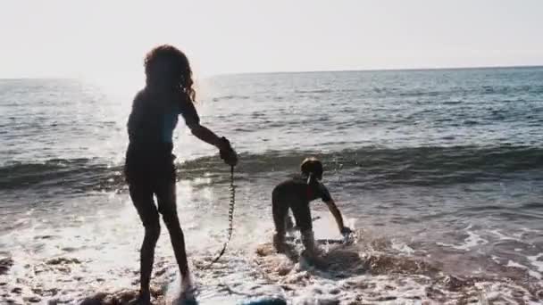 Two Children Wearing Wetsuits Playing Waves Bodyboards Summer Beach Vacation — Stock Video