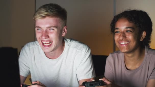 Teenage Couple Holding Control Pads Sitting Front Computer Screen Home — Stock Video