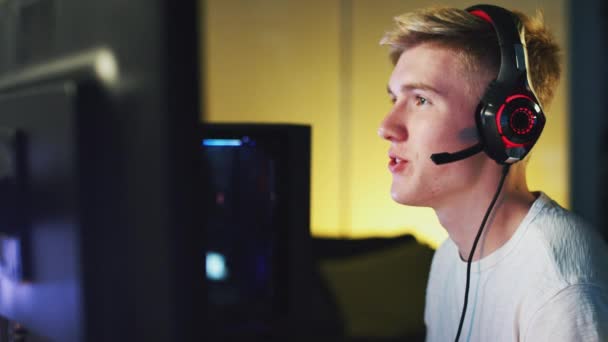 Teenage Boy Wearing Headset Sitting Front Dual Computer Screens Home — Stock video