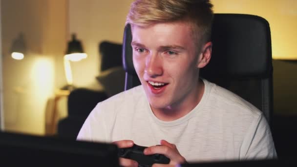 Teenage Boy Holding Control Pad Sitting Front Computer Screen Home — Stock Video