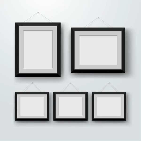 Leere Bilderrahmen an der Wand. Design für einen modernen Innenraum. vertikal und horizontal a-4. Vektorillustration. isoliert auf grauem Hintergrund — Stockvektor