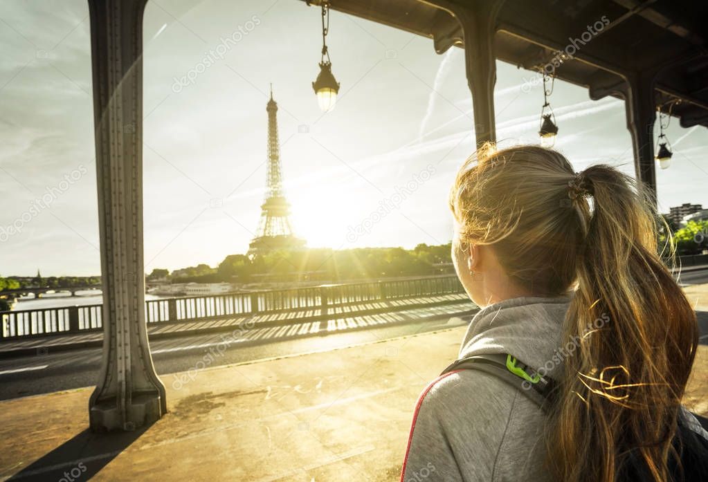 woman tourist in front of the Eiffel Tower in Paris, France