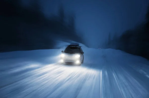 Car lights in winter forest — Stock Photo, Image