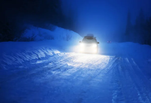 Car lights in winter forest — Stock Photo, Image