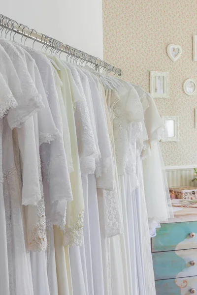 Interior of bridal salon. Beautiful wedding dress on a hangers. — Stock Photo, Image