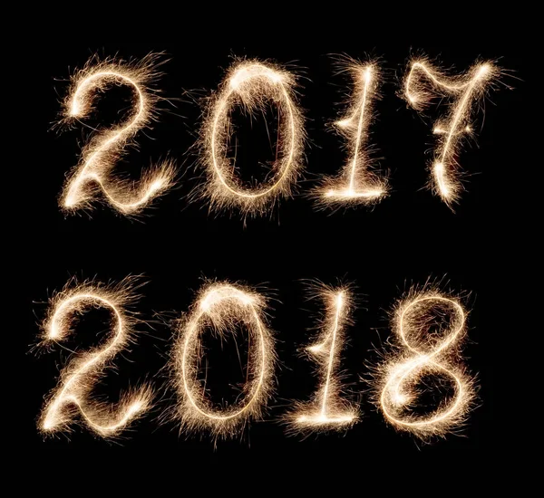 Isolated 2017-2018 written with Sparkler firework on black Stock Photo