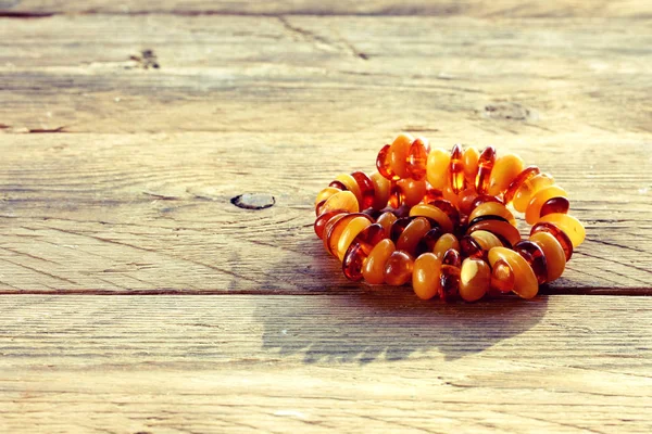 Amber beads on table — Stock Photo, Image