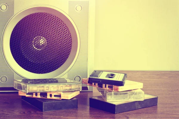 Old music speaker, heap of audio cassettes — Stock Photo, Image