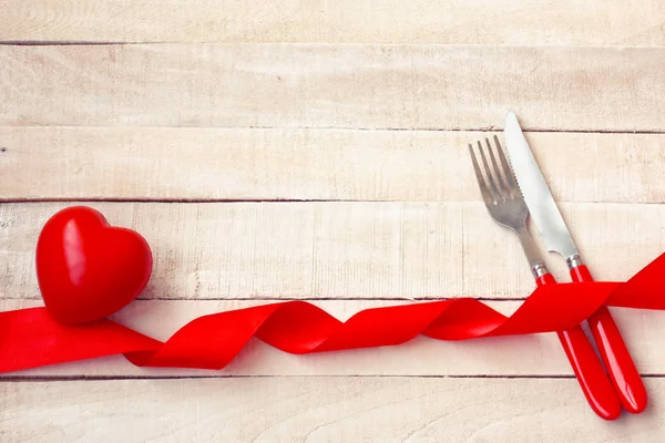 Valentines day background, holiday dinner, knife, fork, red hear