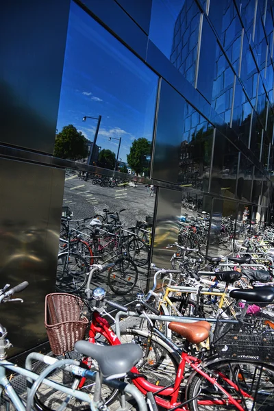 Bicycle rack reflected on glass-material facade Royalty Free Stock Images