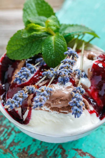 Ice cream with berry topping and lavender.