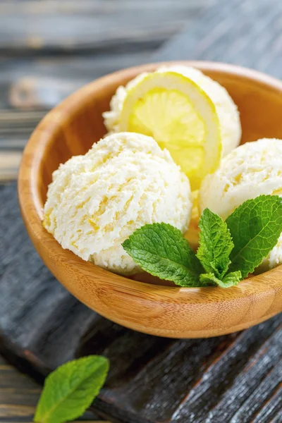 Homemade lemon ice cream in a wooden bowl.