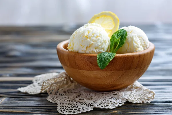 Lemon ice cream in a wooden bowl.