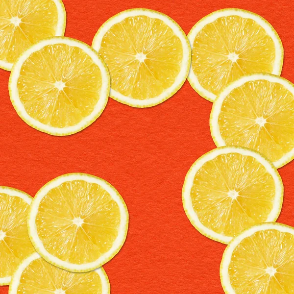 Yellow lemon slices on Red Background — Stock Photo, Image