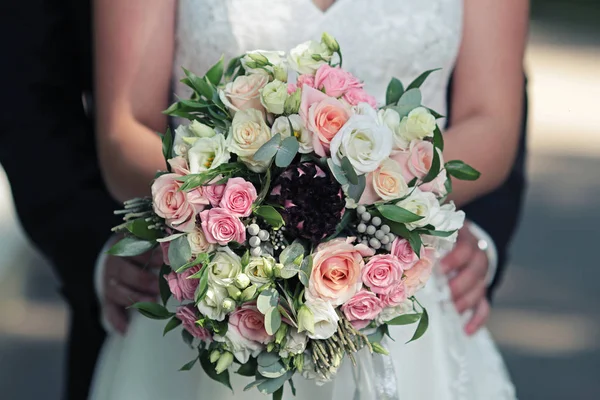 Bright wedding bouquet in hands — Stock Photo, Image