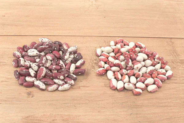 Piles of beans on wooden board — Stock Photo, Image