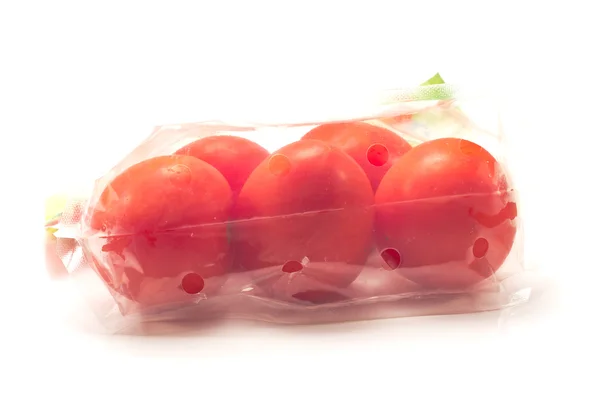Tomatoes in a plastic bag package isolated on white — Stock fotografie