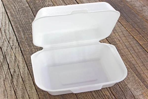 Styrofoam box for food on wooden table — Stock Photo, Image