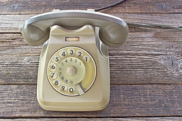 Old telephone on wooden background — Stock Photo, Image