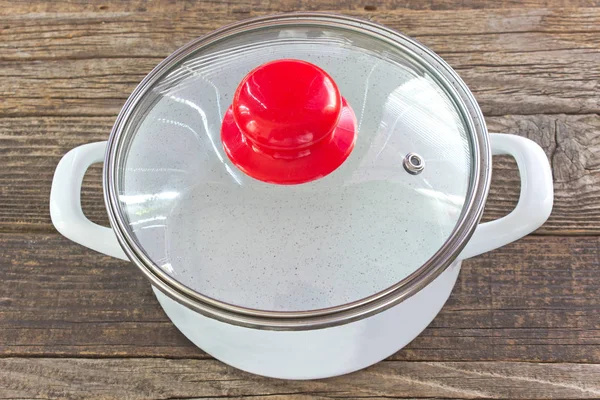 Cooking pot with lid  on wooden background — Stock Photo, Image