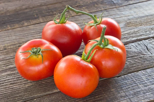 Tomato on old wooden background — Stock Photo, Image