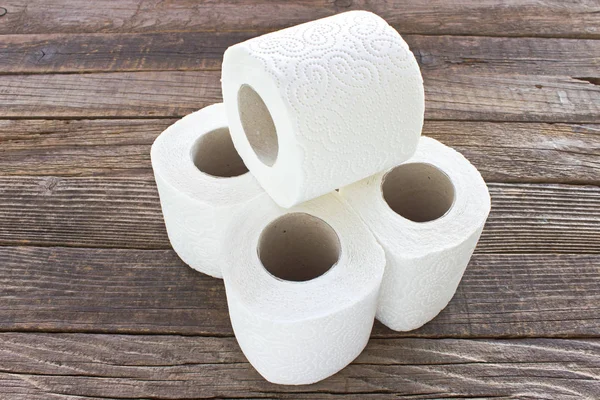 Toilet paper rolls on wood background — Stock Photo, Image