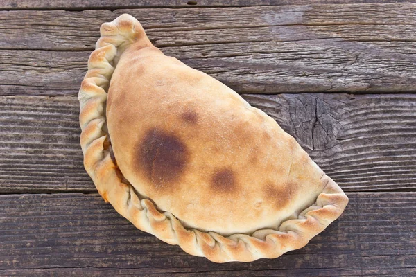 Cornish pasty on wooden background — Stock Photo, Image