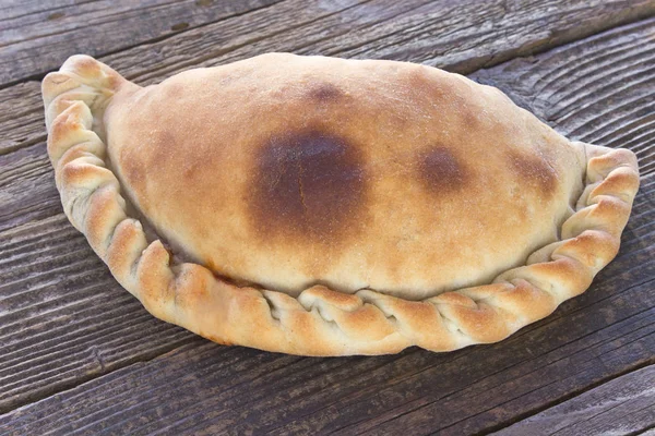 Cornish pasty on wooden background — Stock Photo, Image