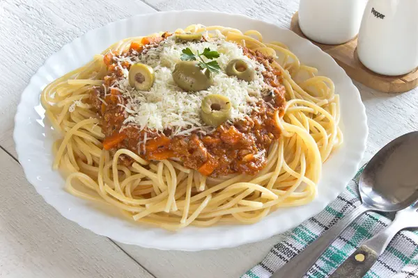 Spaghetti bolognese  in plate on wooden table — Stock Photo, Image
