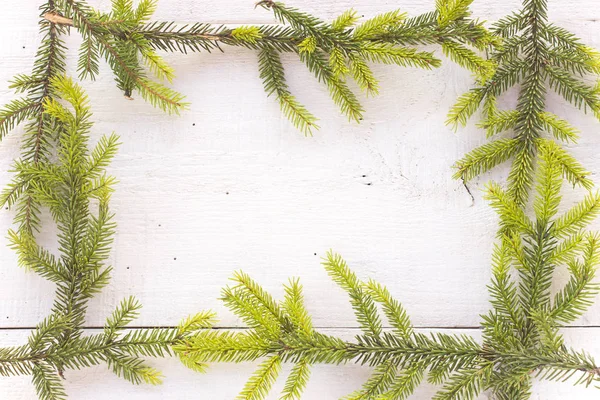 Merry Christmas frame with pine tree needles on white