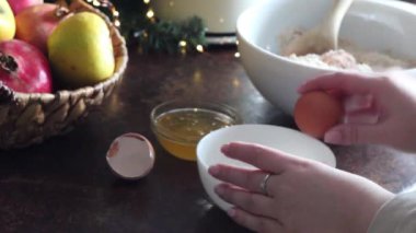 A female chef cuts the white and yolk for baking