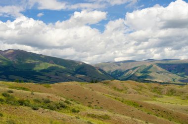 Yemyeşil bulutlar ile dağları arasında güzel güneşli Vadisi