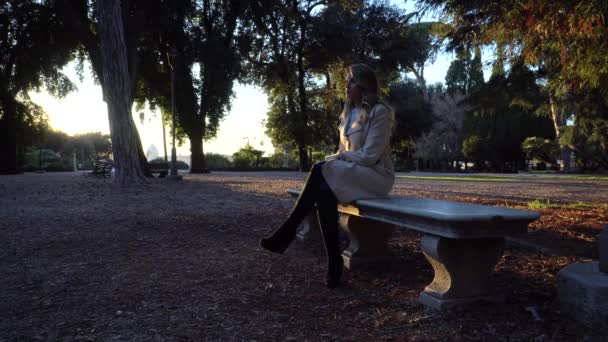 Woman Sitting Stone Bench Autumn Park Sunset — Stock Video