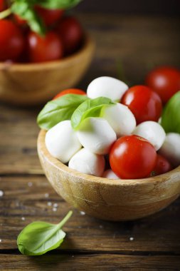 Mozzarella peyniri, domates ve fesleğen ile İtalyan meze ahşap kase hizmet