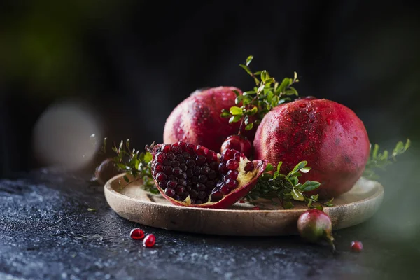 Sweet red pomegranate with green leaves — Stock Photo, Image