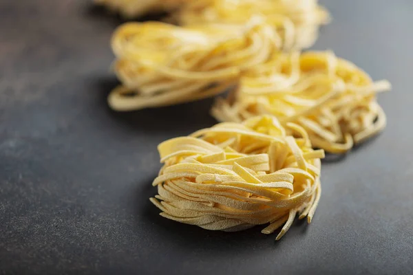Italian raw pasta tagliatelle — Stock Photo, Image