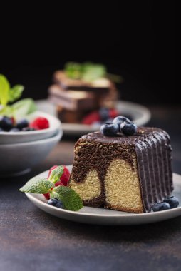 Sweet marble plumcake with chocolate and berry, selective focus image