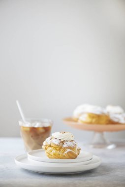 Dessert custard cakes with cream and powdered sugar, selective focus image
