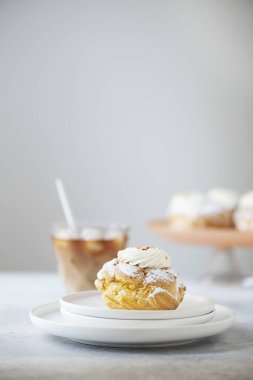 Dessert custard cakes with cream and powdered sugar, selective focus image