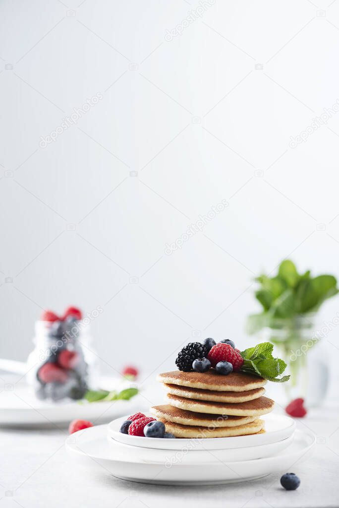 Sweet pancakes with berry and mint, selective focus image