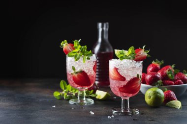 Gradient cocktail with strawberry, lime, mint and crused ice, selective focus