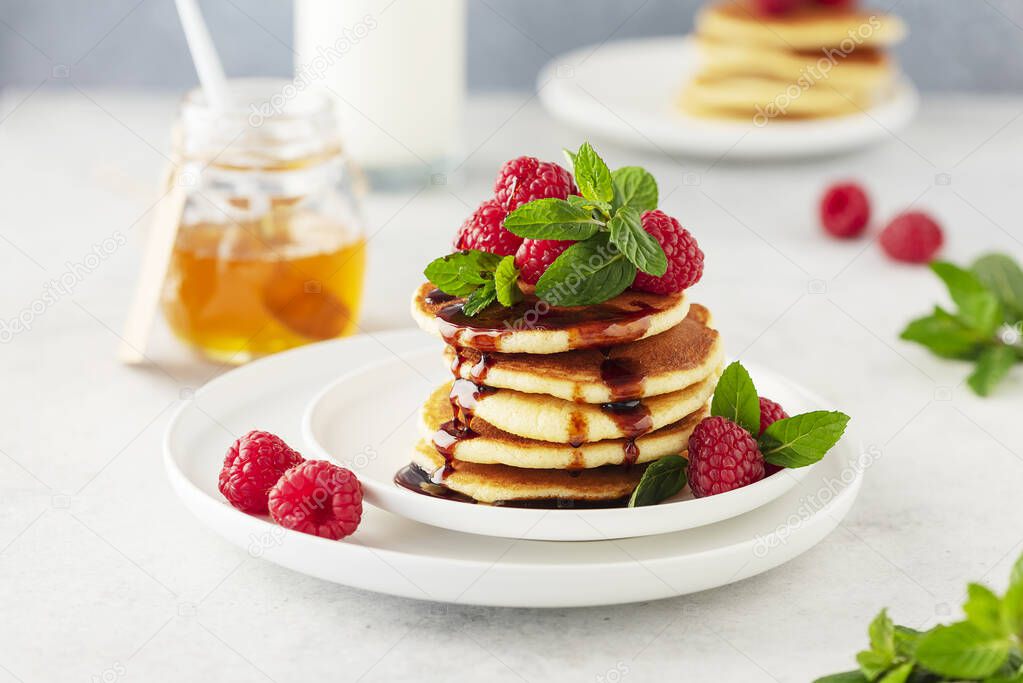 Sweet pancakes with raspberry, mint and caramel, selective focus image