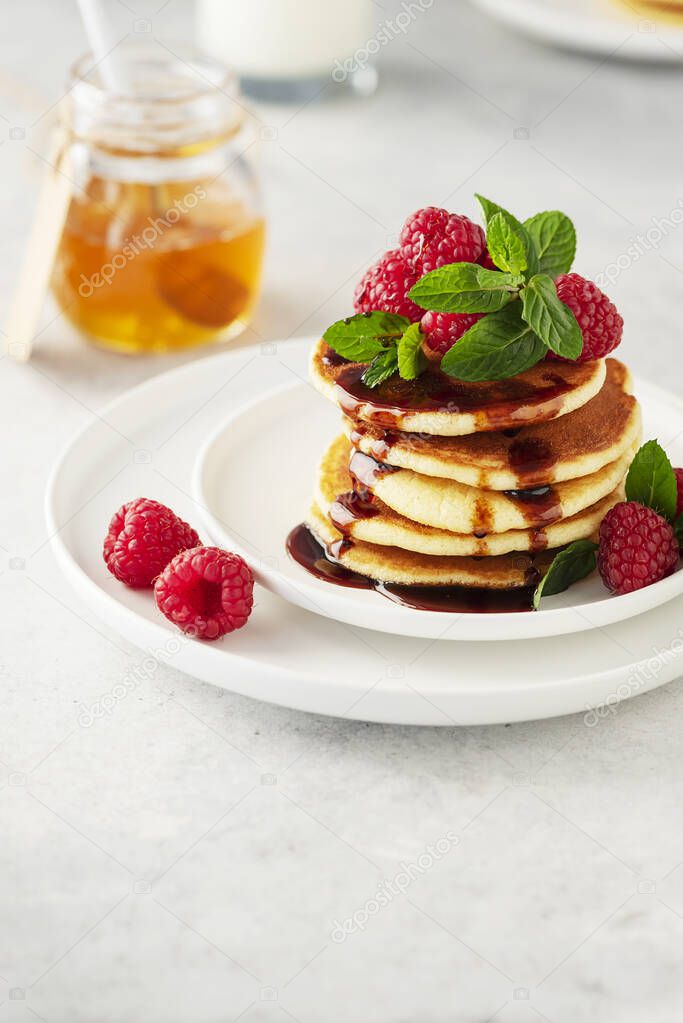 Sweet pancakes with raspberry, mint and caramel, selective focus image