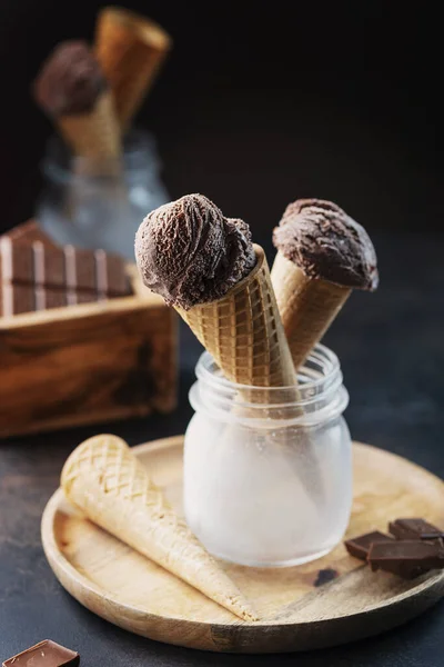 Tasty chocolate ice cream on the black table, selective focus image