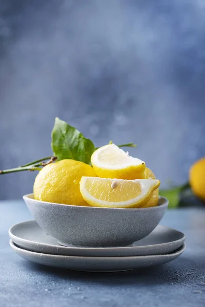 Fresh Sicilians lemons in the ceramic bowl, selective focus image