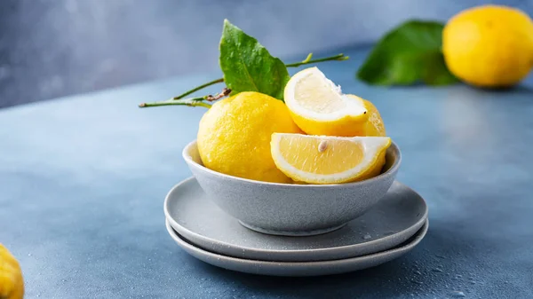Fresh Sicilians lemons in the ceramic bowl, selective focus image and slider format