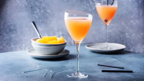 Traditional Italian cocktail bellini with prosecco and peaches, selective focus image and slider format