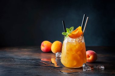 Bar konsepti ve yaz içkileri konsepti. Kayısı, buz ve nane arkaplanda bir bardak yaz kokteyli. Seçici odak resmi.