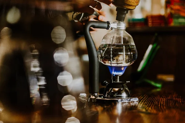 Siphon vacuum coffee maker on cafe bar